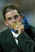 27 August 2004; Ireland's Cian O'Connor kisses his Gold Medal after winning the Individual Jumping Competition. Markopoulo Olympic Equestrian Centre. Games of the XXVIII Olympiad, Athens Summer Olympics Games 2004, Athens, Greece. Picture credit; Brendan Moran / SPORTSFILE