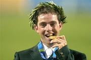 27 August 2004; Ireland's Cian O'Connor bites his Gold Medal after winning the Individual Jumping Competition on Waterford Crystal. Markopoulo Olympic Equestrian Centre. Games of the XXVIII Olympiad, Athens Summer Olympics Games 2004, Athens, Greece. Picture credit; Brendan Moran / SPORTSFILE