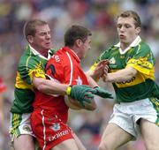 29 August 2004; Gavin Donaghy, Derry, is tackled by Dara O Cinneide, left, and Paddy Kelly, Kerry. Bank of Ireland Senior Football Championship Semi-Final, Derry v Kerry, Croke Park, Dublin. Picture credit; Ray McManus / SPORTSFILE