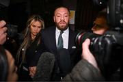 22 November 2024; Mr Conor McGregor leaves court, accompanied by his partner Dee Devlin, after the court announced the jury’s decision in the civil action case, P Ní Laimhin v McGregor & Anor, in High Court 24 at Chancery Place in Dublin. Photo by David Fitzgerald/Sportsfile