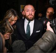 22 November 2024; Mr Conor McGregor leaves court, accompanied by his partner Dee Devlin, after the court announced the jury’s decision in the civil action case, P Ní Laimhin v McGregor & Anor, in High Court 24 at Chancery Place in Dublin. Photo by David Fitzgerald/Sportsfile