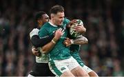 23 November 2024; Jacob Stockdale of Ireland is tackled by Vuate Karawalevu of Fiji during the Autumn Nations Series match between Ireland and Fiji at the Aviva Stadium in Dublin. Photo by Brendan Moran/Sportsfile