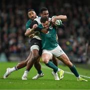 23 November 2024; Jacob Stockdale of Ireland is tackled by Vuate Karawalevu of Fiji during the Autumn Nations Series match between Ireland and Fiji at the Aviva Stadium in Dublin. Photo by Brendan Moran/Sportsfile
