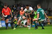 23 November 2024; Kitione Salawa of Fiji kicks on despite the efforts of Jacob Stockdale of Ireland during the Autumn Nations Series match between Ireland and Fiji at the Aviva Stadium in Dublin. Photo by Shauna Clinton/Sportsfile