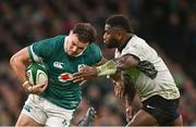 23 November 2024; Jacob Stockdale of Ireland is tackled by Josua Tuisova of Fiji during the Autumn Nations Series match between Ireland and Fiji at the Aviva Stadium in Dublin. Photo by Ben McShane/Sportsfile