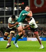 23 November 2024; Stuart McCloskey of Ireland is tackled by Fiji players Mesake Vocevoce, left, and Peni Matawalu during the Autumn Nations Series match between Ireland and Fiji at the Aviva Stadium in Dublin. Photo by Shauna Clinton/Sportsfile