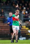 24 November 2024; Seán Hahessy of Rathgormack is shown a yellow card by referee Niall Quinn during the AIB Munster GAA Senior Club Football Championship semi-final match between Rathgormack and Dr Crokes at Fraher Field in Dungarvan, Waterford. Photo by Michael P Ryan/Sportsfile