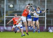 24 November 2024; Dan McCarthy of Clann Éireann in action against Niall Kelly, left, and Cormac Quinn of Errigal Ciaran during the AIB Ulster GAA Senior Club Football Championship semi-final match between Clann Éireann and Errigal Ciaran at Páirc Esler in Newry, Down. Photo by Stephen Marken/Sportsfile