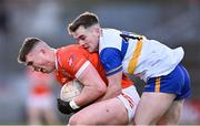 24 November 2024; Tiernan Kelly of Clann Éireann in action against Ruairi Canavan of Errigal Ciaran during the AIB Ulster GAA Senior Club Football Championship semi-final match between Clann Éireann and Errigal Ciaran at Páirc Esler in Newry, Down. Photo by Stephen Marken/Sportsfile