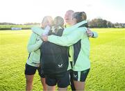 26 November 2024; FAI International Awards recipients, from left, Katie McCabe, International Goal of the Year award (FIFA Women's World Cup v Canada); goalkeeper Courtney Brosnan, Senior Women's International Player of the Year; and Heather Payne, Women's Young Player of the Year; are congratulated by Julie-Ann Russell after a Republic of Ireland women training session at the FAI National Training Centre in Abbotstown, Dublin. Photo by Stephen McCarthy/Sportsfile