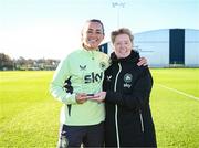 26 November 2024; Katie McCabe is presented with her International Goal of the Year award (FIFA Women's World Cup v Canada) by head coach Eileen Gleeson after a Republic of Ireland women training session at the FAI National Training Centre in Abbotstown, Dublin. Photo by Stephen McCarthy/Sportsfile