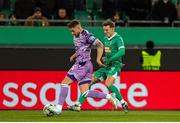 28 November 2024; Lee Grace of Shamrock Rovers in action against Bendegúz Bolla of SK Rapid during the UEFA Conference League 2024/25 league phase match between SK Rapid and Shamrock Rovers at the Allianz Stadion in Vienna, Austria. Photo by Tom Seiss/Sportsfile
