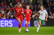 29 November 2024; Rhiannon Roberts of Wales in action against Julie-Ann Russell of Republic of Ireland during the UEFA Women's EURO 2025 Play-off Round Two first leg match between Wales and Republic of Ireland at Cardiff City Stadium in Wales. Photo by Stephen McCarthy/Sportsfile