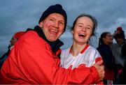 30 November 2024; Mairead Clancy of Mungret St Paul's celebrates with her old school principal Paddy O'Neill after her side's victory in the AIB LGFA All-Ireland Junior Club Championship semi-final match between Coolera/Strandhill of Sligo and Mungret St Paul's of Limerick at Kilcoyne Park in Tubbercurry, Sligo. Photo by Shauna Clinton/Sportsfile
