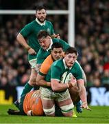 30 November 2024; Joe McCarthy of Ireland is tackled by Jeremy Williams, left, and Allan Alaalatoa of Australia during the Autumn Nations Series match between Ireland and Australia at the Aviva Stadium in Dublin. Photo by Ramsey Cardy/Sportsfile