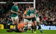 30 November 2024; Joe McCarthy of Ireland is tackled by Jeremy Williams, left, and Allan Alaalatoa of Australia during the Autumn Nations Series match between Ireland and Australia at the Aviva Stadium in Dublin. Photo by Ramsey Cardy/Sportsfile