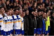 8 December 2024; Errigal Ciarán manager Enda McGinley, centre, stands with his players and backroom staff during the playing of the National Anthem before the AIB Ulster GAA Senior Club Football Championship final match between Errigal Ciarán of Tyrone and Kilcoo of Down at BOX-IT Athletic Grounds in Armagh. Photo by Ramsey Cardy/Sportsfile