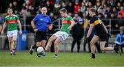 8 December 2024; Noel McGrath of Loughmore Castleiney passes under pressure from Mark O'Shea of Dr Crokes during the AIB Munster GAA Senior Club Football Championship final match between Dr Crokes of Kerry and Loughmore Castleiney of Tipperary at Mallow GAA Grounds in Cork. Photo by Piaras Ó Mídheach/Sportsfile