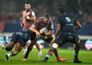 13 December 2024; Peter O'Mahony of Munster is tackled by Andrea Cocagi and Leone Nakarawa of Castres Olympique during the Champions Cup Pool 3 match between Castres Olympique and Munster at Stade Pierre Fabre in Castres, France. Photo by Brendan Moran/Sportsfile