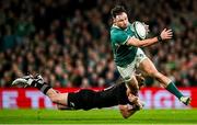 8 November 2024; Hugo Keenan of Ireland is tackled by Damian McKenzie of New Zealand during the Autumn Nations Series match between Ireland and New Zealand at the Aviva Stadium in Dublin. Photo by Seb Daly/Sportsfile