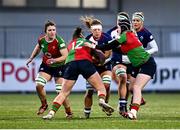 22 December 2024; Claire Boles of Wolfhounds is tackled by Clovers players Enya Breen, left, and Beth Buttimer during the Celtic Challenge match between Wolfhounds and Clovers at Energia Park in Dublin. Photo by Seb Daly/Sportsfile