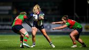 22 December 2024; Stacey Flood of Wolfhounds in action against Clovers players Jane Neill, left, and Enya Breen during the Celtic Challenge match between Wolfhounds and Clovers at Energia Park in Dublin. Photo by Seb Daly/Sportsfile