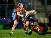 22 December 2024; Aoife Dalton of Wolfhounds is tackled by Clovers players Enya Breen, left, and Beth Buttimer during the Celtic Challenge match between Wolfhounds and Clovers at Energia Park in Dublin. Photo by Seb Daly/Sportsfile