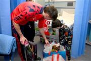23 December 2024; Shelbourne player Sean Boyd with John Paul Mullins, age 5, during a visit to CHI at Temple Street in Dublin. Photo by David Fitzgerald/Sportsfile