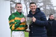 27 December 2024; Jockey Mark Walsh is presented the trophy by golfer Padraig Harrington after winning the Paddy Power Steeple chase 5-y-o plus aboard Perceval Legallois on day two of the Leopardstown Christmas Festival at Leopardstown Racecourse in Dublin. Photo by David Fitzgerald/Sportsfile