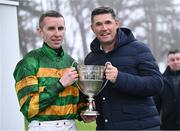 27 December 2024; Jockey Mark Walsh is presented the trophy by golfer Padraig Harrington after winning the Paddy Power Steeple chase 5-y-o plus aboard Perceval Legallois on day two of the Leopardstown Christmas Festival at Leopardstown Racecourse in Dublin. Photo by David Fitzgerald/Sportsfile