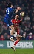 27 December 2024; Billy Burns of Munster and Jimmy O'Brien of Leinster contest a high ball during the United Rugby Championship match between Munster and Leinster at Thomond Park in Limerick. Photo by Seb Daly/Sportsfile