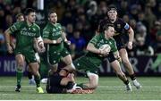28 December 2024; Jack Carty of Connacht is tackled by Ben Carson  of Ulster during  the United Rugby Championship match between Connacht and Ulster at the Dexcom Stadium in Galway. Photo by John Dickson/Sportsfile