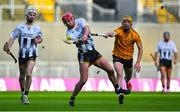 12 January 2025; James Maher of St Lachtain's scores a point despite the efforts of Luke Duggan Murray of Russell Rovers during the AIB GAA Hurling All-Ireland Junior Club Championship final match between St Lachtain's of Kilkenny and Russell Rovers of Cork at Croke Park in Dublin. Photo by Shauna Clinton/Sportsfile