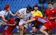 15 January 2025; Marc Lawless of Presentation College, Bray is tackled by David Ginnelly, left, and Ryan Brazel of CUS during the Bank of Ireland Leinster Rugby Boys Schools Vinnie Murray Cup quarter-final match between CUS and Presentation College, Bray at Energia Park in Dublin. Photo by Tyler Miller/Sportsfile