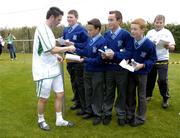 1 September 2004; Robbie Keane, Republic of Ireland, signs autographs for local schoolboys at the end of squad training. Malahide FC, Malahide, Co. Dublin. Picture credit; David Maher / SPORTSFILE