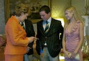 1 September 2004; President of Ireland, Mary McAleese admires the Gold Medal won by Irish showjumper Cian O'Connor, in the company of Rachel Wise and Irish Chef de Mission William O'Brien (hidden) at a reception, held in Aras an Uachtarain, in honour of the Irish team's achievement at the 2004 Olympic Games in Athens recently. Picture credit; Brendan Moran / SPORTSFILE