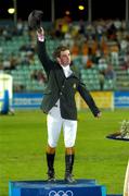 27 August 2004; Ireland's Cian O'Connor steps onto the podium to receive his Gold medal that he won in the Individual Jumping Competition on Waterford Crystal. Markopoulo Olympic Equestrian Centre. Games of the XXVIII Olympiad, Athens Summer Olympics Games 2004, Athens, Greece. Picture credit; Brendan Moran / SPORTSFILE