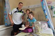 29 September 2013; Clare's Colin Ryan, left, and Padraic Collins with ten year old Aisling Keogh, from Raharney, Co. Westmeath, and the Liam MacCarthy cup on a visit by the All-Ireland Senior Hurling Champions to Our Lady's Hospital for Sick Children, Crumlin. Picture credit: Matt Browne / SPORTSFILE