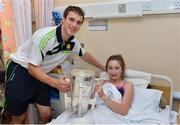 29 September 2013; Clare's Pat O'Connor with thirteen year old Jodie Vard, from Dalkey, Co. Dublin, and the Liam MacCarthy cup on a visit by the All-Ireland Senior Hurling Champions to Our Lady's Hospital for Sick Children, Crumlin. Picture credit: Matt Browne / SPORTSFILE