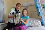29 September 2013; Clare's Padraic Collins with ten year old Aisling Keogh, from Raharney, Co. Westmeath, and the Liam MacCarthy cup on a visit by the All-Ireland Senior Hurling Champions to Our Lady's Hospital for Sick Children, Crumlin. Picture credit: Matt Browne / SPORTSFILE