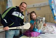 29 September 2013; Clare manager Davy Fitzgerald with ten year old Aisling Keogh, from Raharney, Co. Westmeath, and the Liam MacCarthy cup on a visit by the All-Ireland Senior Hurling Champions to Our Lady's Hospital for Sick Children, Crumlin. Picture credit: Matt Browne / SPORTSFILE