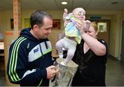29 September 2013; Clare manager Davy Fitzgerald with 6 month old Emma Monahan and her mother Sinead, from Ballymote, Co. Sligo, and the Liam MacCarthy cup on a visit by the All-Ireland Senior Hurling Champions to Our Lady's Hospital for Sick Children, Crumlin. Picture credit: Matt Browne / SPORTSFILE