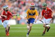 28 September 2013; Fionn Devlin, from Edendork P.S, Coalisland Road, Dungannon, Co. Tyrone, representing Clare, in action against Oisín Larkin, from St. Brendan's NS, Portumna, Co. Galway, representing Cork, left, and Ryan McCarthy, from St. Fergal's NS, Killeagh, Co. Cork. INTO/RESPECT Exhibition GoGames during the GAA Hurling All-Ireland Senior Championship Final Replay between Cork and Clare, Croke Park, Dublin. Picture credit: Stephen McCarthy / SPORTSFILE