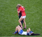 29 September 2013; Juliet Murphy, Cork, is congratulated by the team masseuse Eleanor Lucey as Monaghan's Cathriona McConnell lies dejected on the ground. TG4 All-Ireland Ladies Football Senior Championship Final, Cork v Monaghan, Croke Park, Dublin. Picture credit: Ray McManus / SPORTSFILE