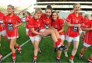 29 September 2013; Cork's Orlagh Farmer, centre, is carried by her team-mates Emma Farmer, 21, and Sarah Harrington, 25, as they celebrate after defeating Monaghan. TG4 All-Ireland Ladies Football Senior Championship Final, Cork v Monaghan, Croke Park, Dublin. Picture credit: Brendan Moran / SPORTSFILE