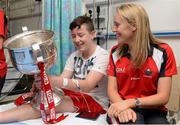 30 September 2013; Cork's Nollaig Cleary with Tyler Cumberton, age 14, from Hardwicke Street, Dublin, and the Brendan Martin cup on a visit by the All-Ireland Ladies Football Champions to Temple Street Children's University Hospital, Temple Street, Dublin.  Picture credit: Brendan Moran / SPORTSFILE