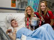 30 September 2013; Cork's Brid Stack and Elaine Scally with Conor Moran, from Whitehall, Dublin, and the Brendan Martin cup on a visit by the All-Ireland Ladies Football Champions to Temple Street Children's University Hospital, Temple Street, Dublin.  Picture credit: Brendan Moran / SPORTSFILE