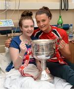 30 September 2013; Cork's Annie Walsh with Lauren Brady, from Belmayne, Dublin, and the Brendan Martin cup on a visit by the All-Ireland Ladies Football Champions to Temple Street Children's University Hospital, Temple Street, Dublin.  Picture credit: Brendan Moran / SPORTSFILE