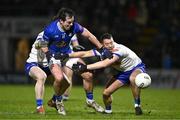 25 January 2025; Gerard Smith of Cavan is tackled by Ryan Wylie, right, and Dylan Byrne of Monaghan during the Allianz Football League Division 2 match between Cavan and Monaghan at Kingspan Breffni in Cavan. Photo by Ben McShane/Sportsfile