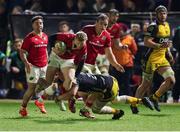 24 January 2025; Ethan Coughlan of Munster is tackled by George Young of Dragons during the United Rugby Championship match between Dragons and Munster at Rodney Parade in Newport, Wales. Photo by Gareth Everett/Sportsfile